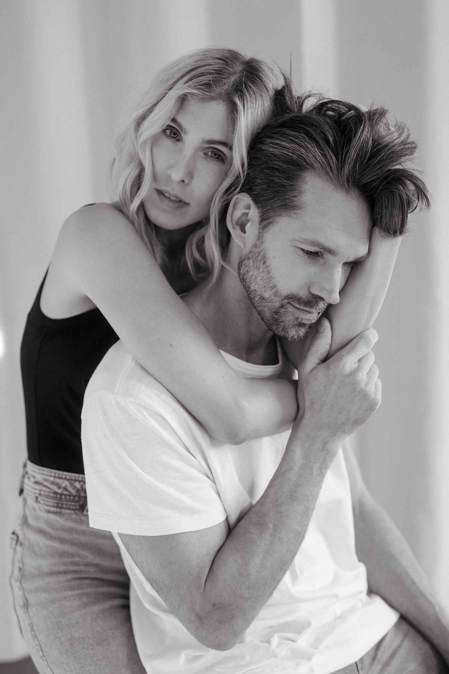 Intimate black and white photoshoot sequence with minimalist styling.