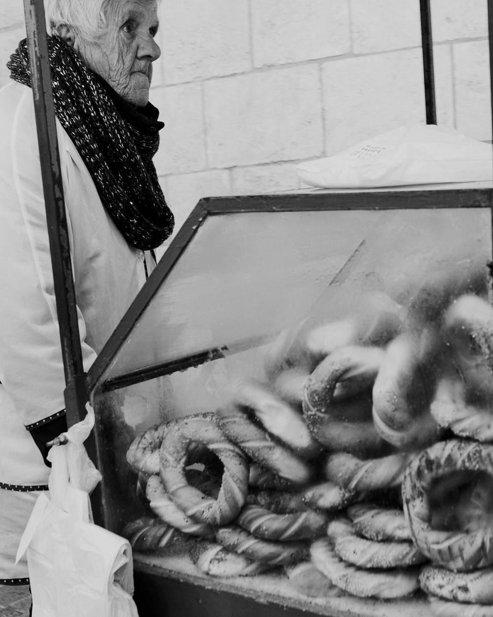 Close-up black and white photograph of fresh baked goods in a display case.