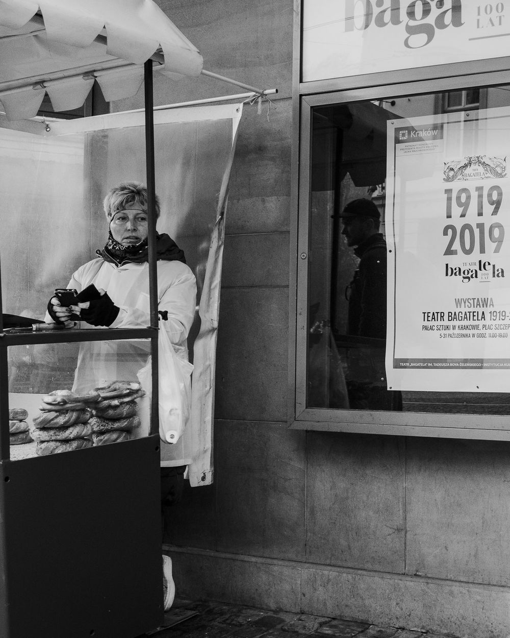 Black and white storefront with vintage signage and window displays.
