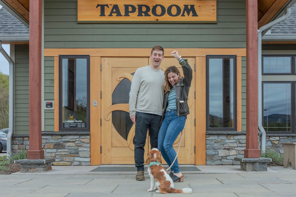 Exterior view of taproom entrance with rustic stone and wood design.