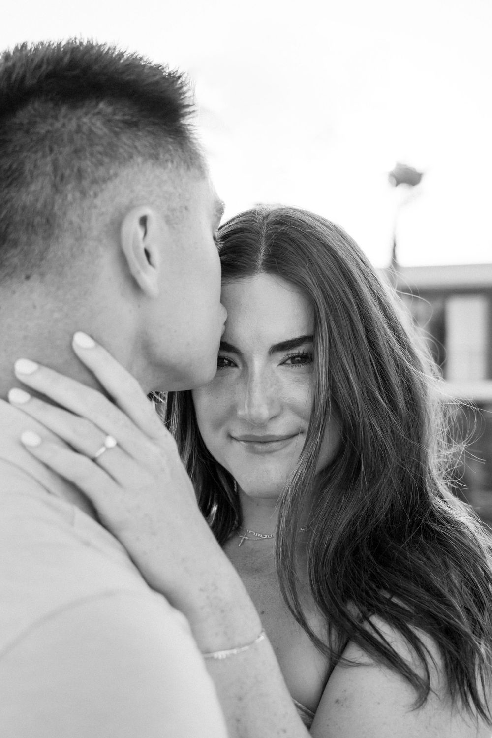 A romantic black and white close-up of a couple sharing an intimate moment.