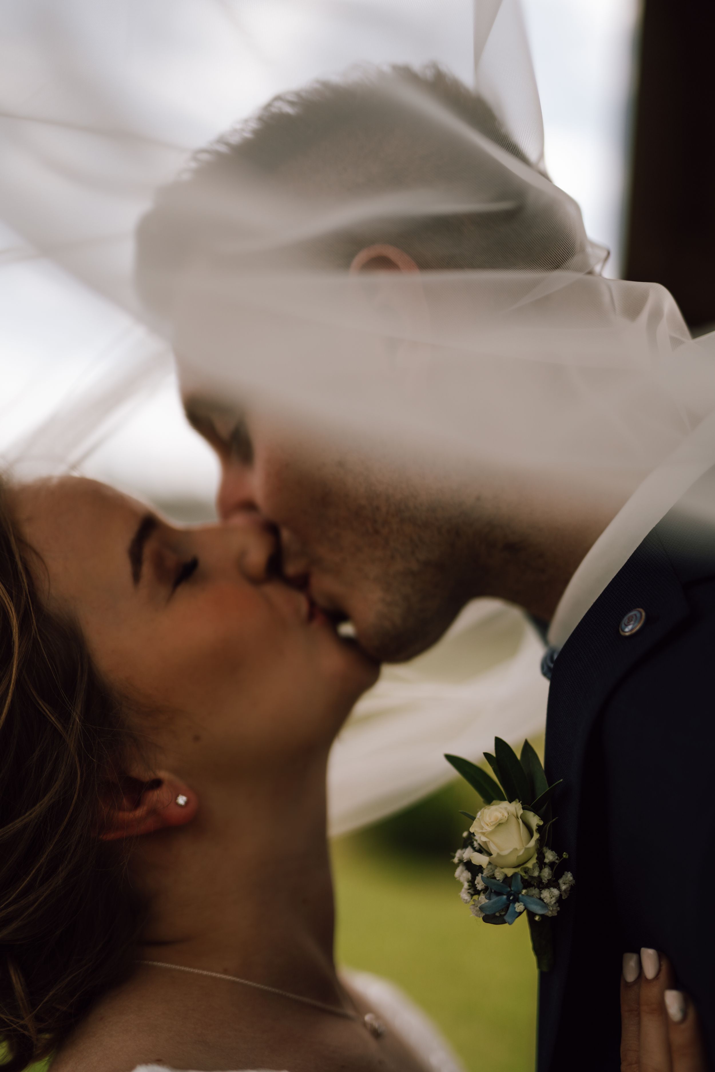 A romantic wedding moment captured through delicate white veil details.