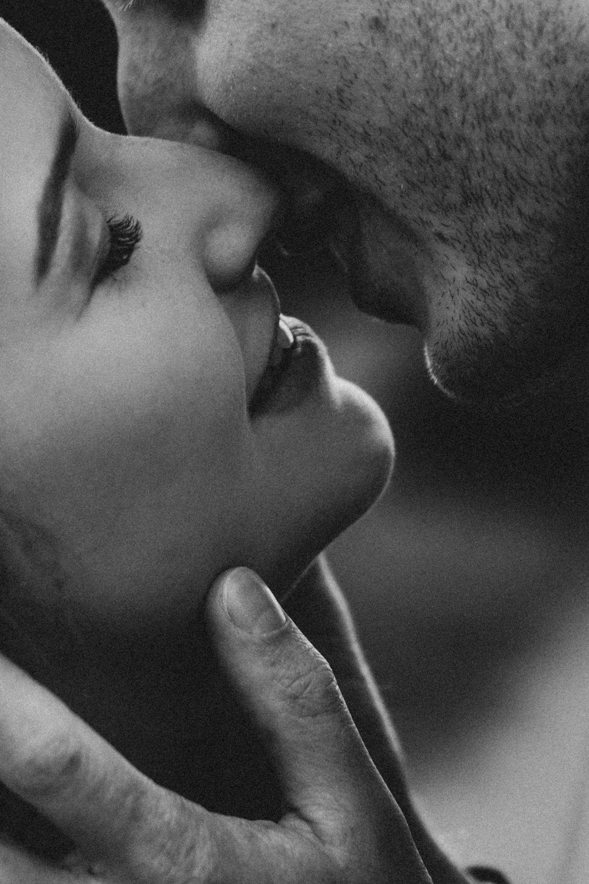 An intimate black and white close-up of a tender romantic moment.