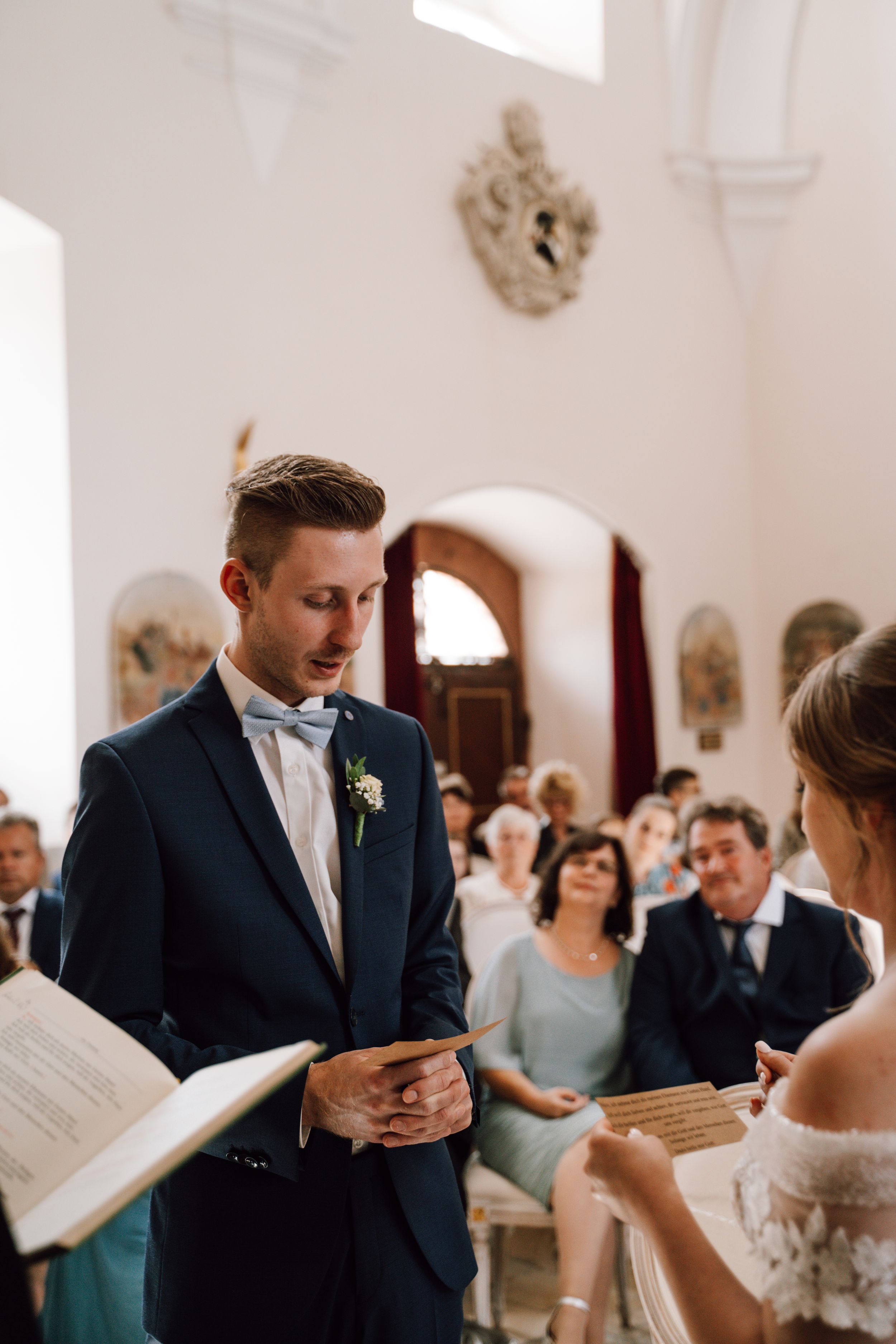 A traditional church wedding ceremony with elegant decor and architectural details.