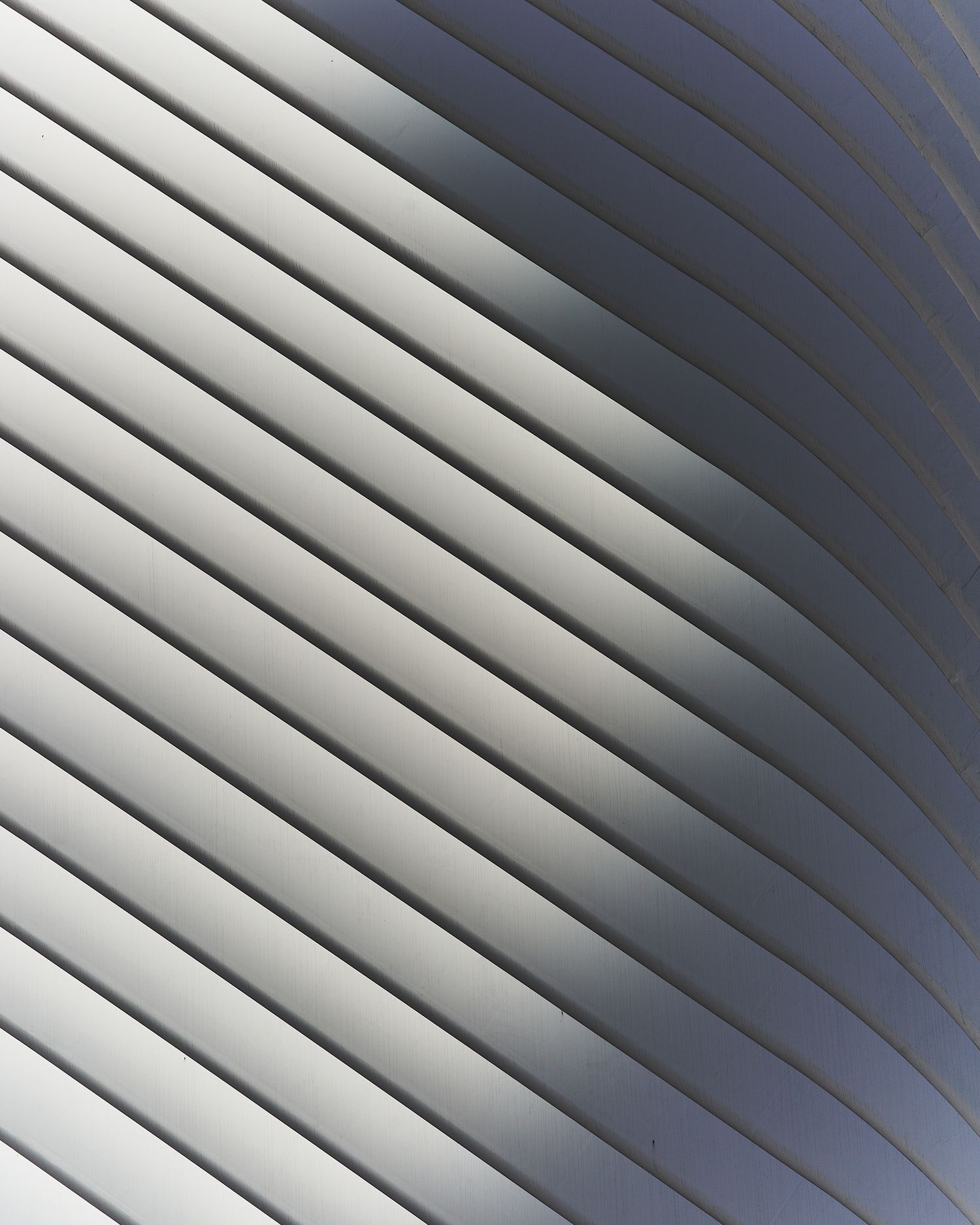 Abstract pattern of diagonal white and gray lines forming a sleek modern architectural detail.