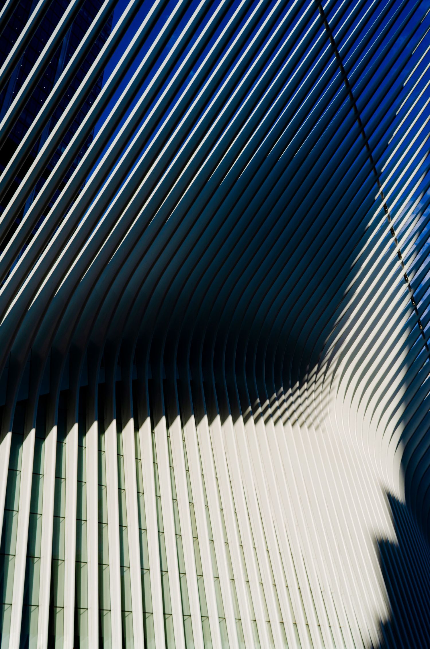 Abstract architectural detail showing diagonal white lines creating geometric shadows and patterns.