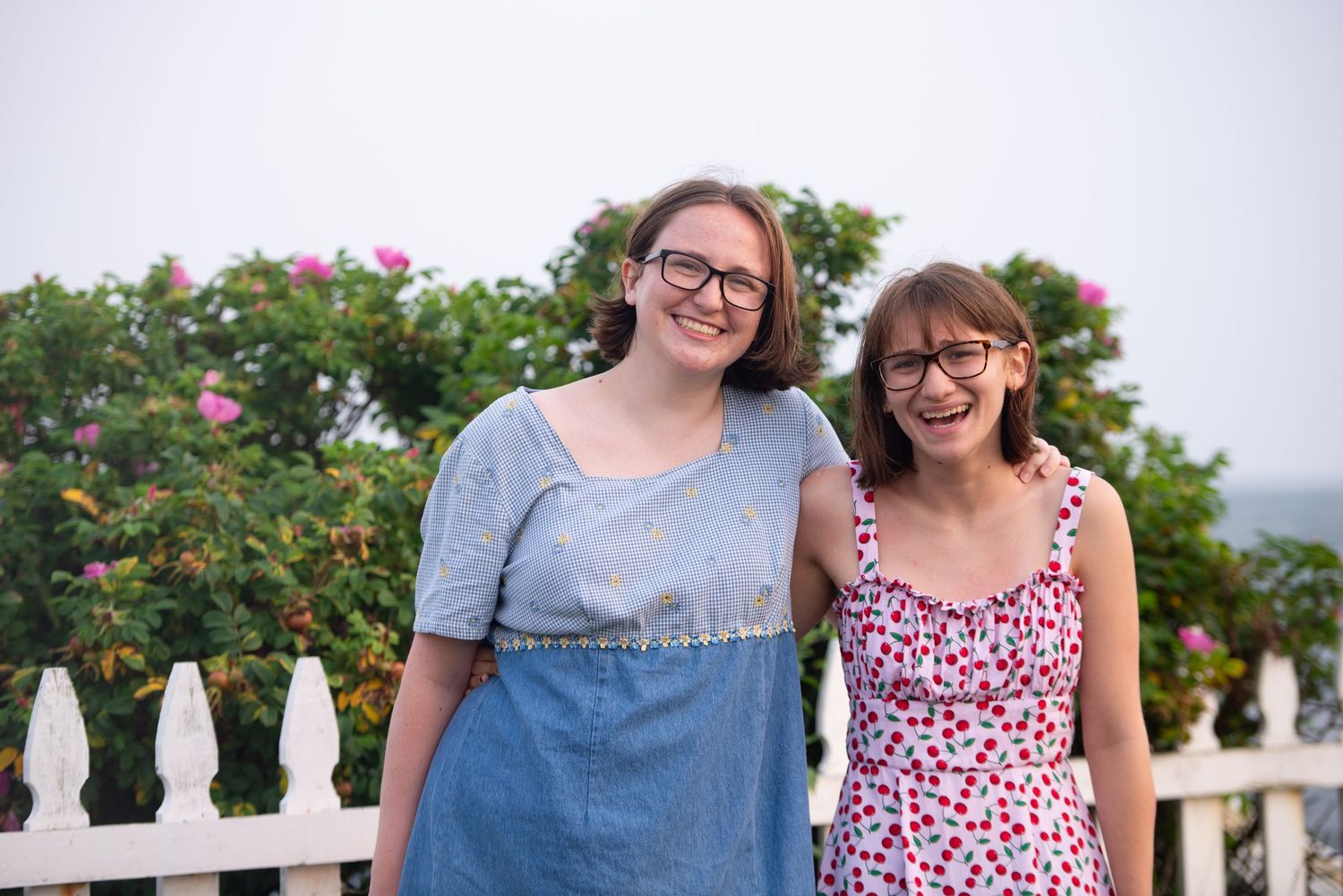 Teen sisters laugh at family vacation portraits in Fairhaven, on the South coast of Massachusetts with Leah Ramuglia Photography.