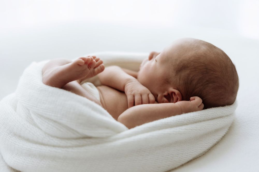 Newborn baby wearing white
