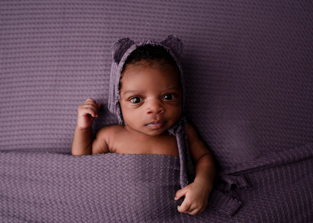 newborn on purple backdrop - Fort Worth Newborn Photoshoot