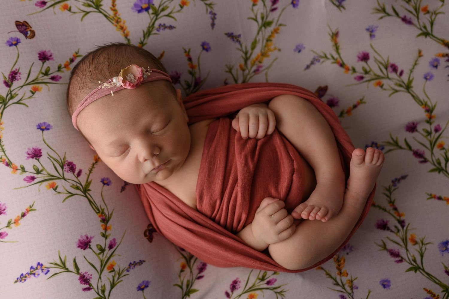 Newborn girl swaddled during newborn portrait session in a professional newborn studio in Arlington Texas