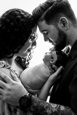 black and white close up image of parents holding their newborn in Arlington Texas