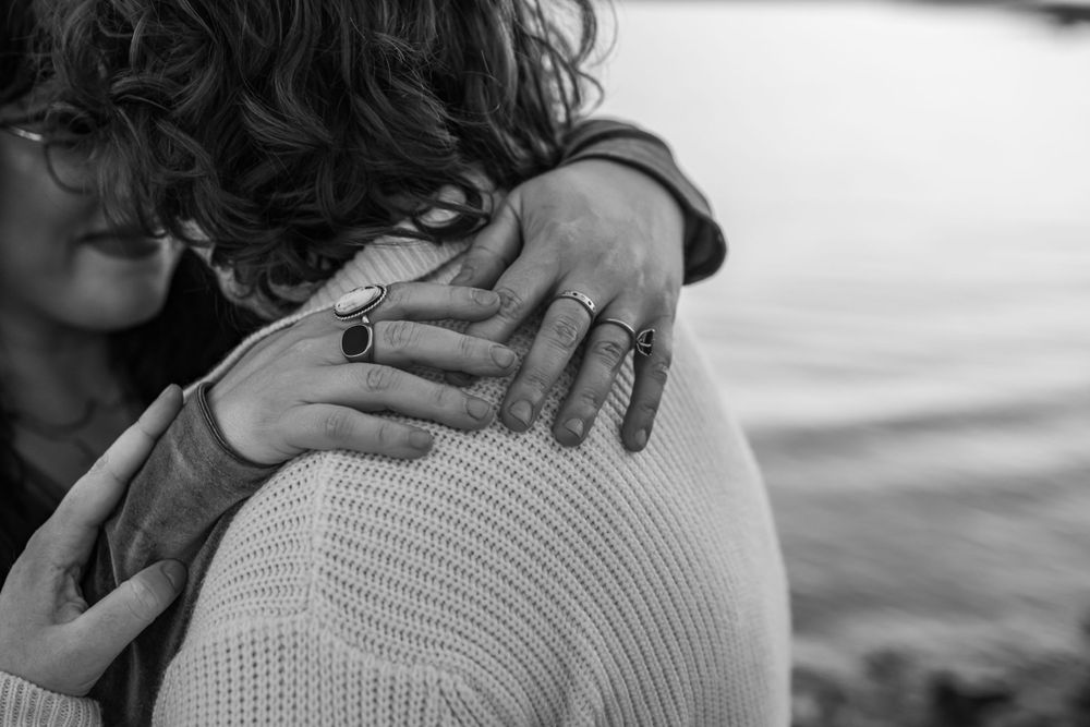 Lesbian couple posed nose to nose lakeside during a lgbtq friendly photoshoot in DFW