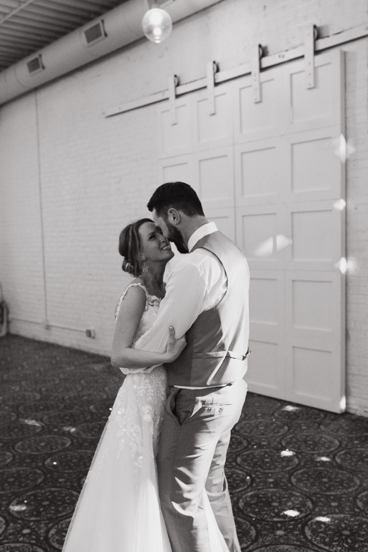 A bride and groom intimately embracing at the Northern Pacific Center wedding venue in Central, Minnesota