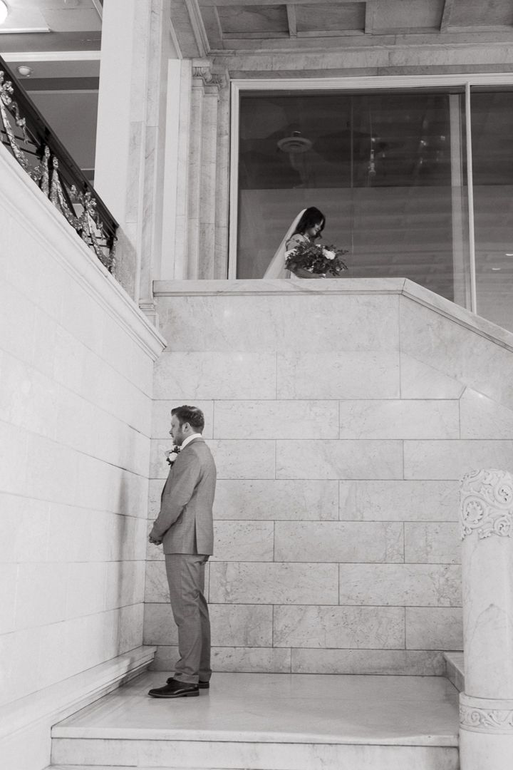 A bride and groom intimately embracing at the Northern Pacific Center wedding venue in Central, Minnesota