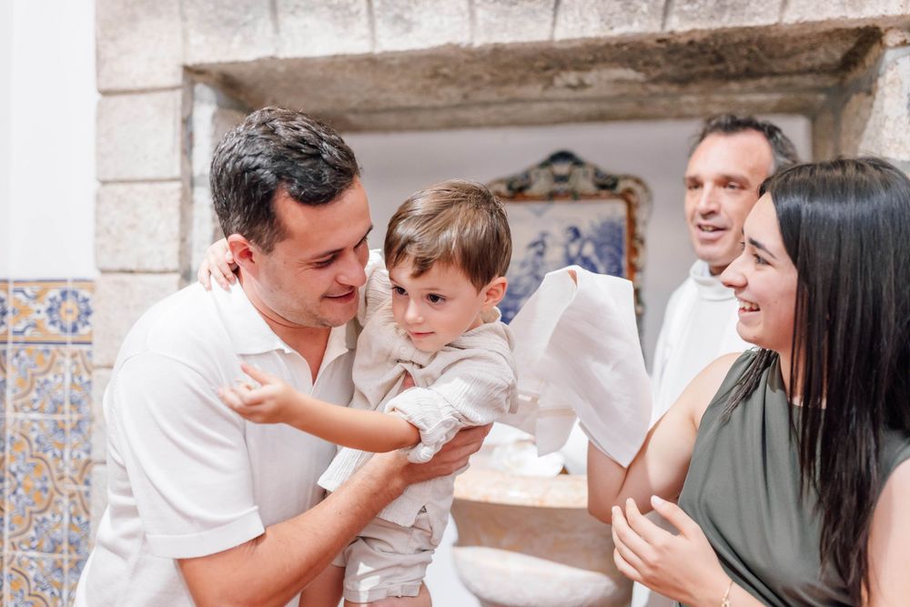 An intimate family moment shared during a religious ceremony.