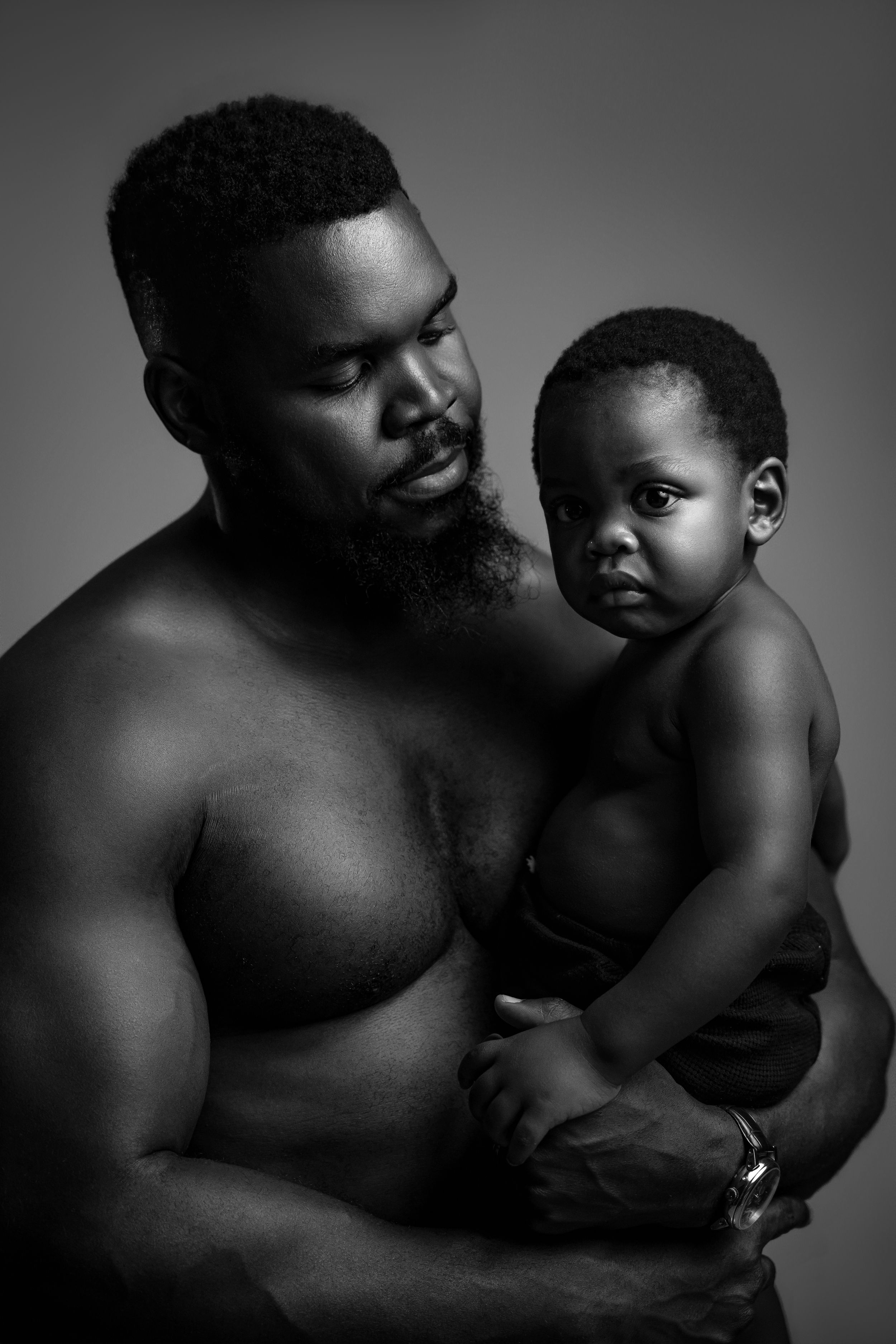 Intimate black and white portrait of father and child showing loving connection.