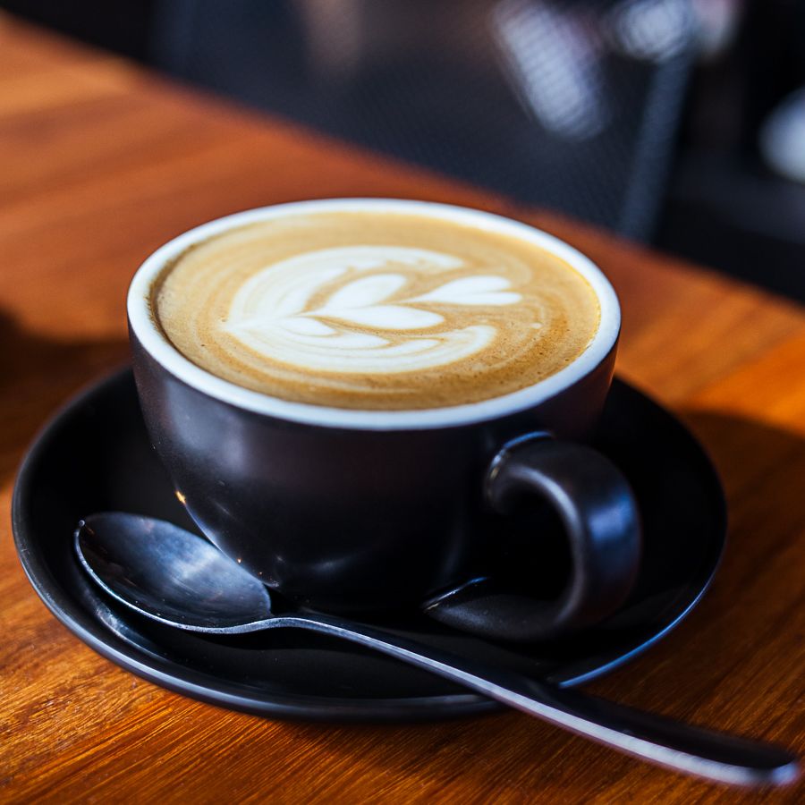 flat white coffee in black cup (flat white cuppa captured by Lesley Marks)