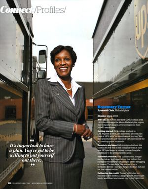 Rosemary Turner, UPS President of Philadelphia, poses confidently in a professional suit beside a UPS truck.