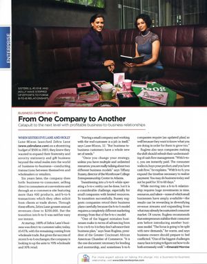 Two business owners smile in a magazine article about growing from small to B2B company success.