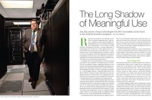 Man stands in a server room for a magazine article about meaningful use of health information technology.