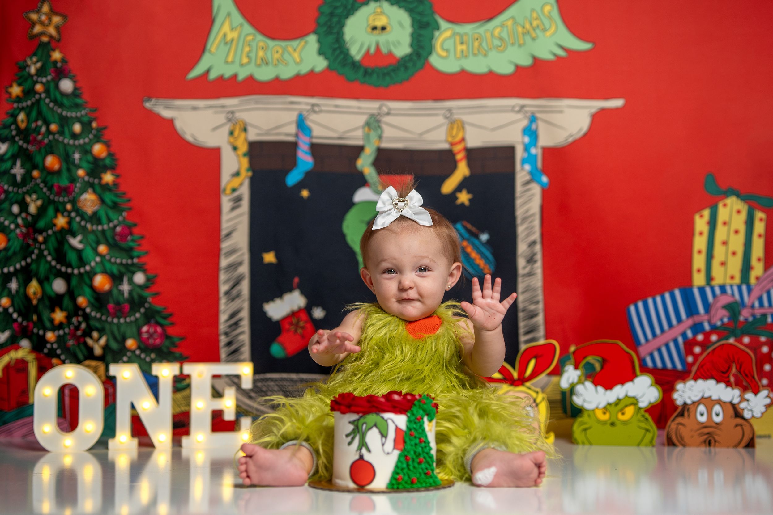 A series of Christmas-themed photo backdrops with decorated trees, presents, and festive red backgrounds.