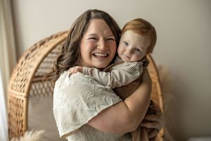 A series of four tender moments showing a parent and child embracing in warm, natural lighting against a neutral wall.