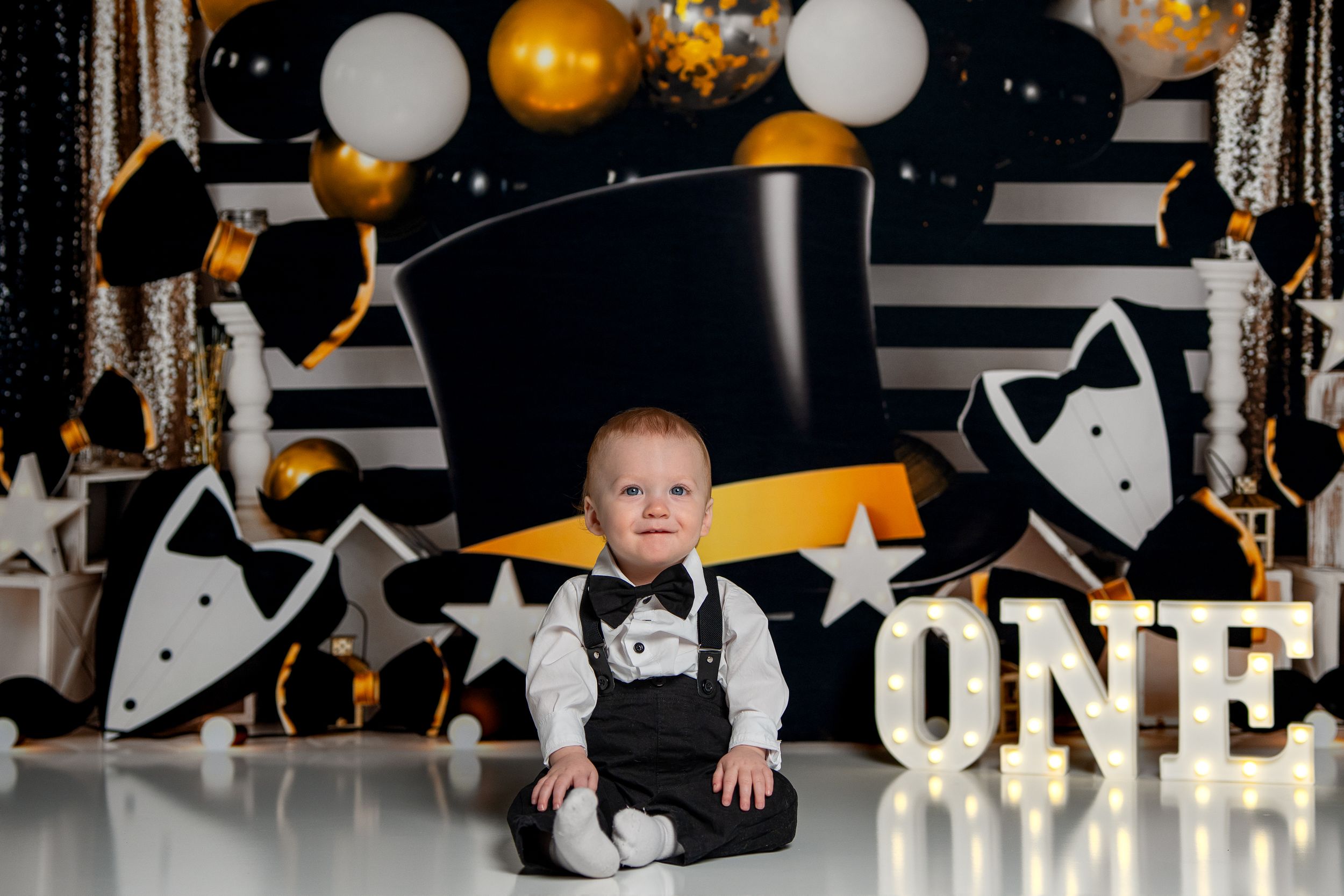 Black and gold themed party decorations with balloons and streamers creating an elegant celebration atmosphere.