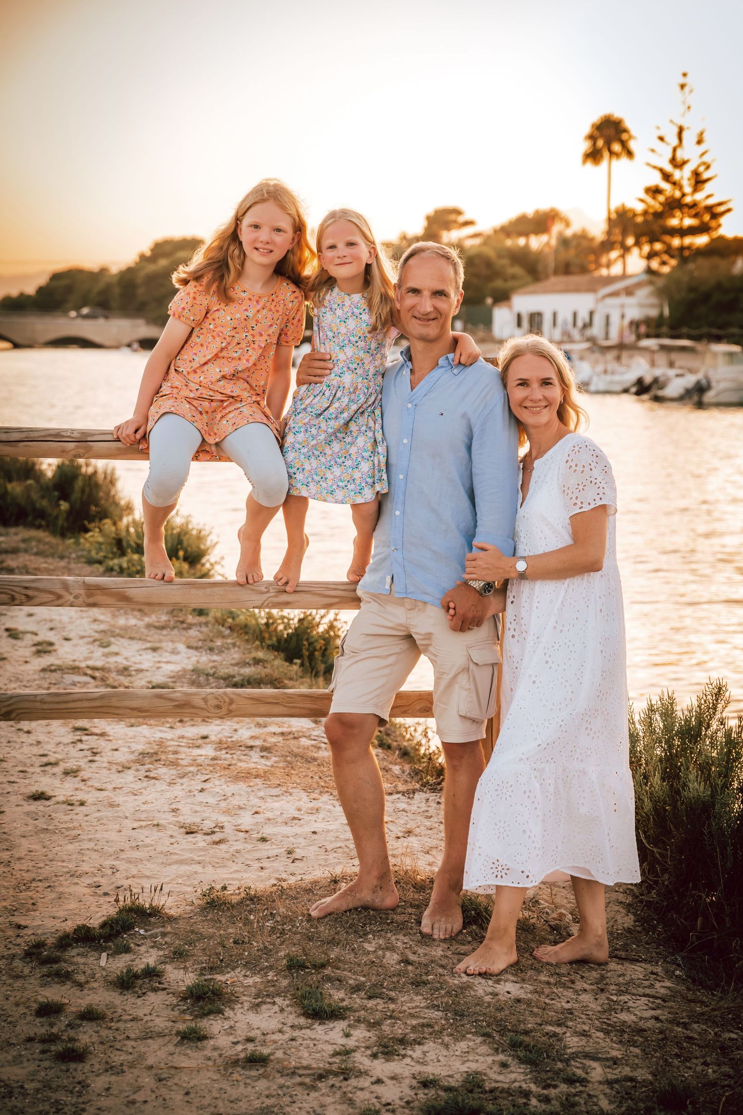 An elegant family portrait standing together on a scenic stone path during a lifestyle session in Mallorca.