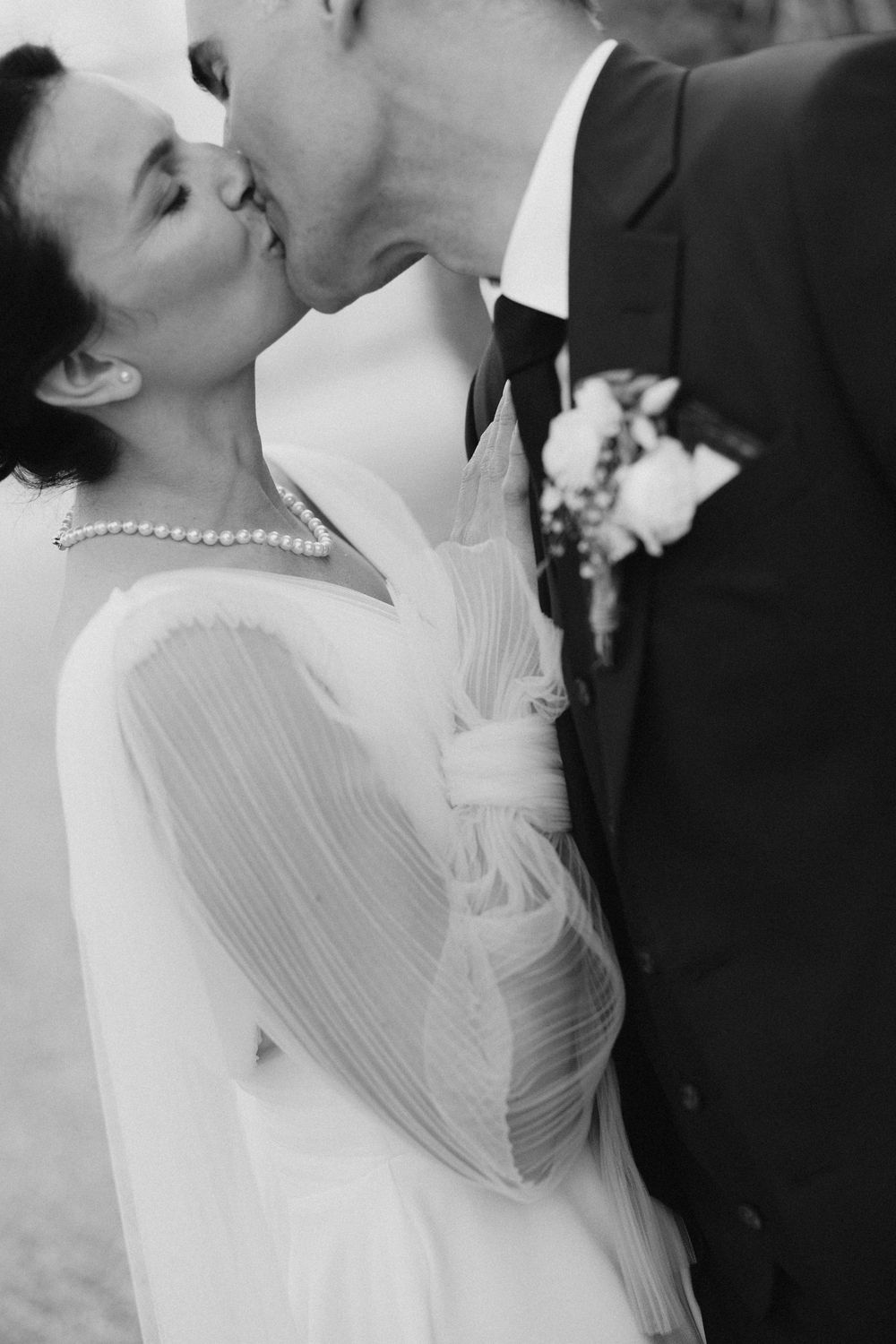 Romantic black and white wedding portrait showing tender moment between newlyweds.