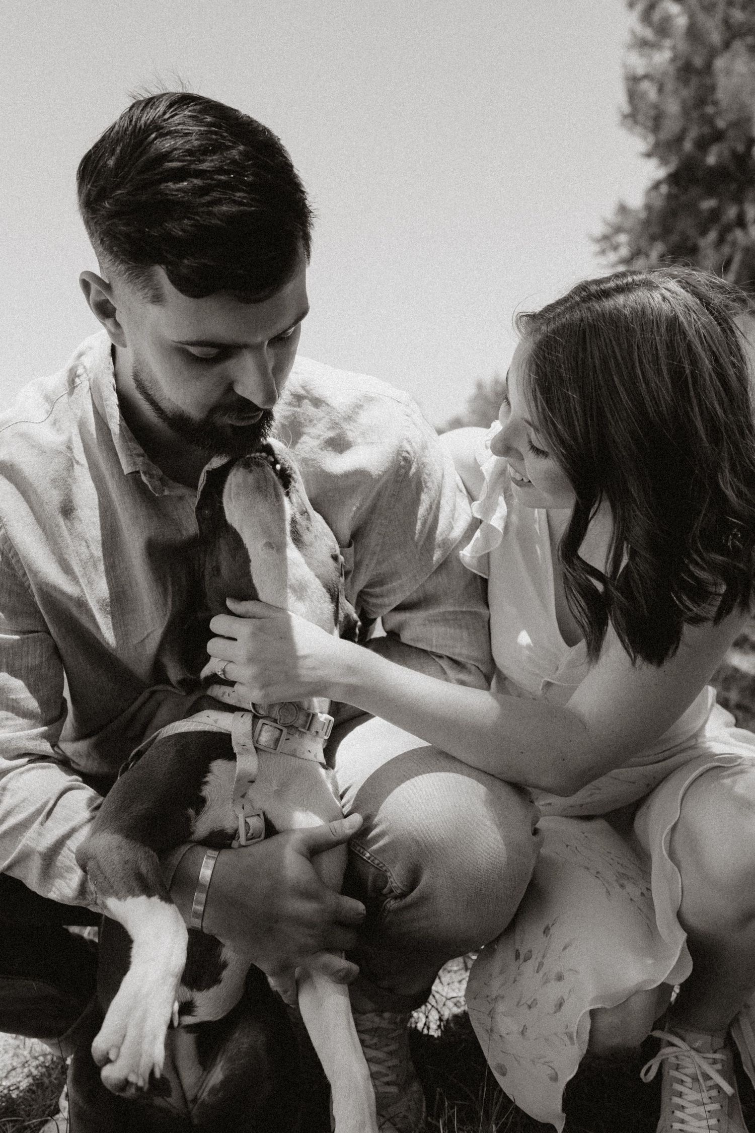 An intimate black and white series showing tender moments between a couple with their pet.