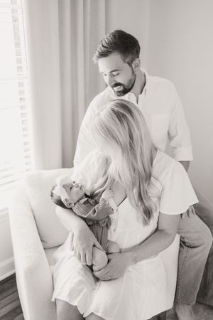 A romantic series of four tender black and white photographs showing an intimate couple embracing indoors.