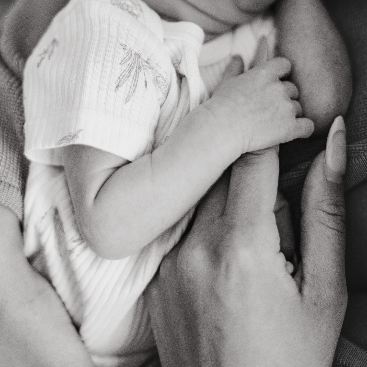 Serene newborn photography captured in a Grand Rapids studio, featuring a peaceful baby posed delicately, perfect for newborn portraits.