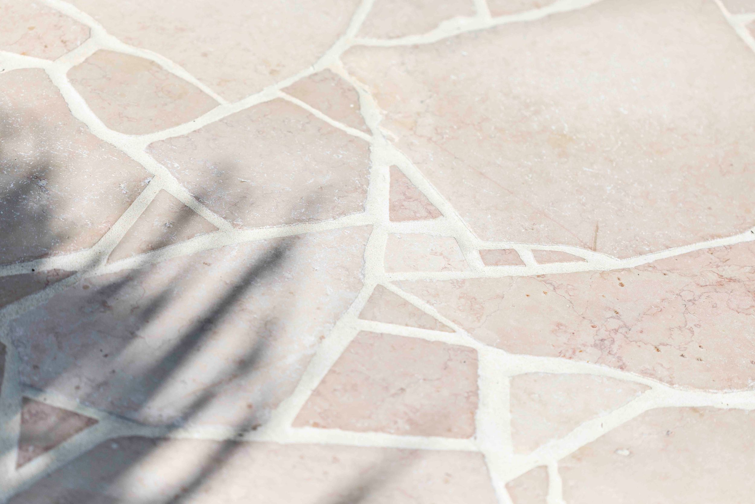 Abstract pattern of white stone tiles with dramatic shadow play.