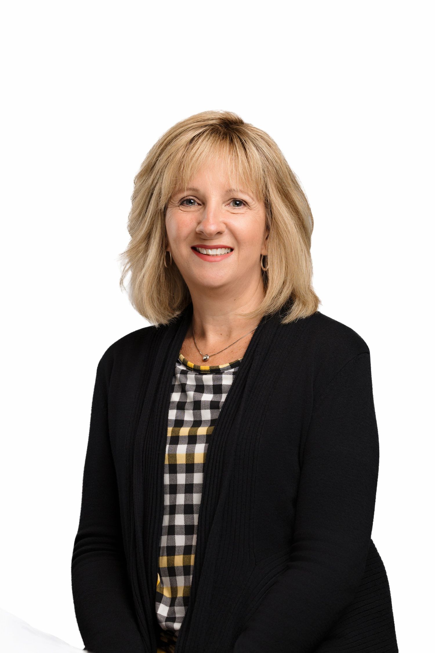 Professional headshots of someone wearing a black blazer and checkered top against white background.