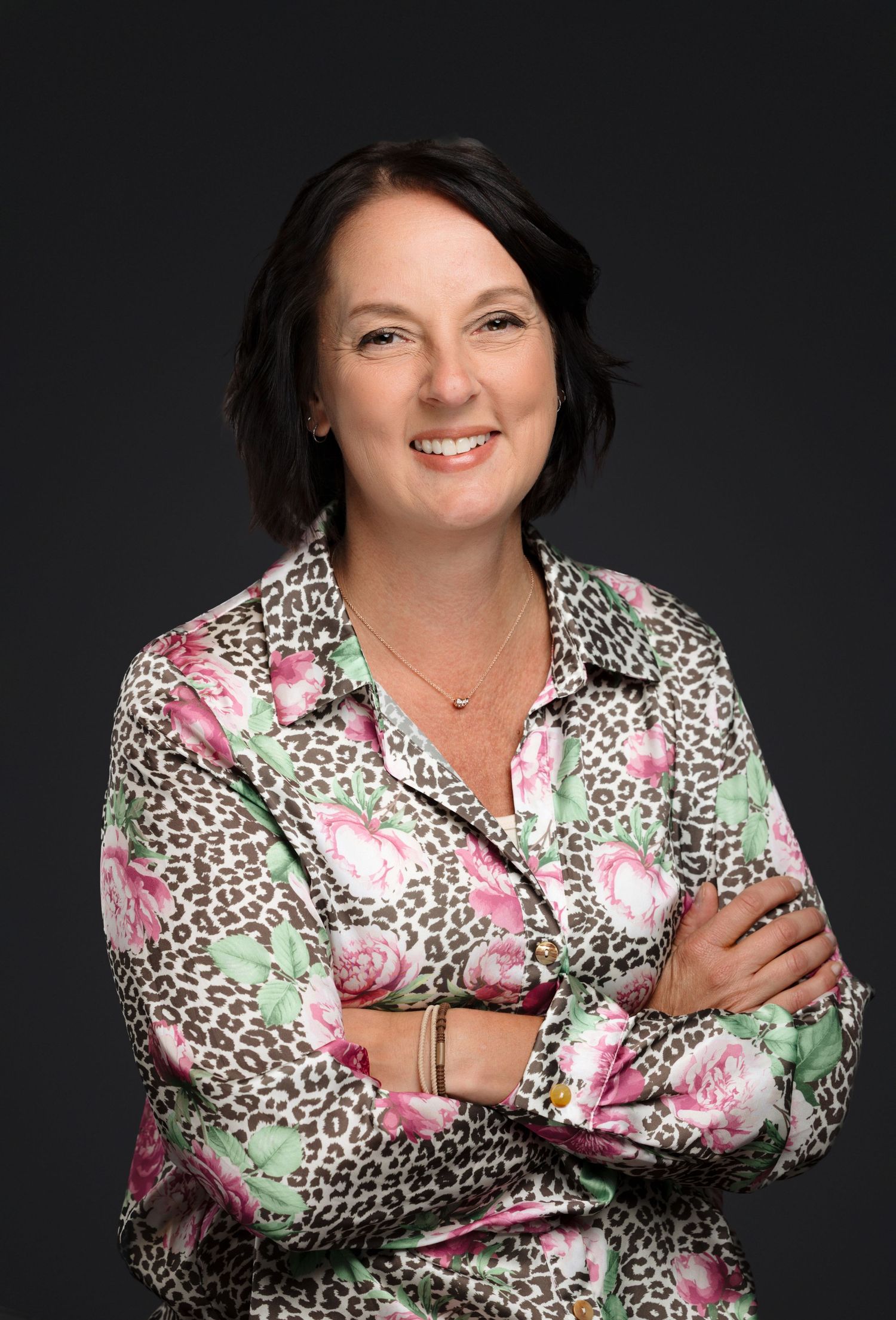 Studio portrait series showing a person in a floral and leopard print blouse against a dark background.