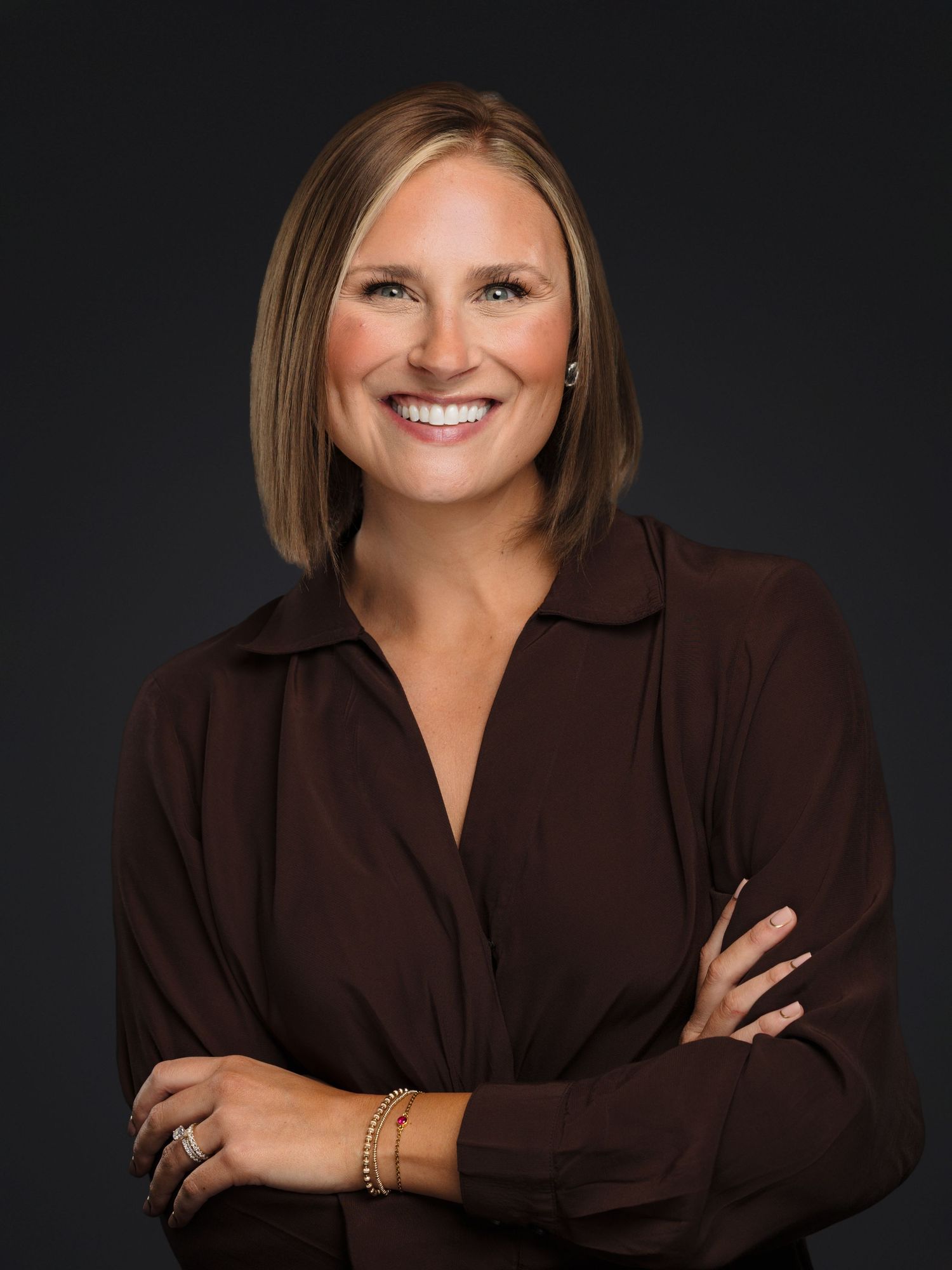 Professional studio portrait series against dark background showing warm expressions and brown button-up shirt.