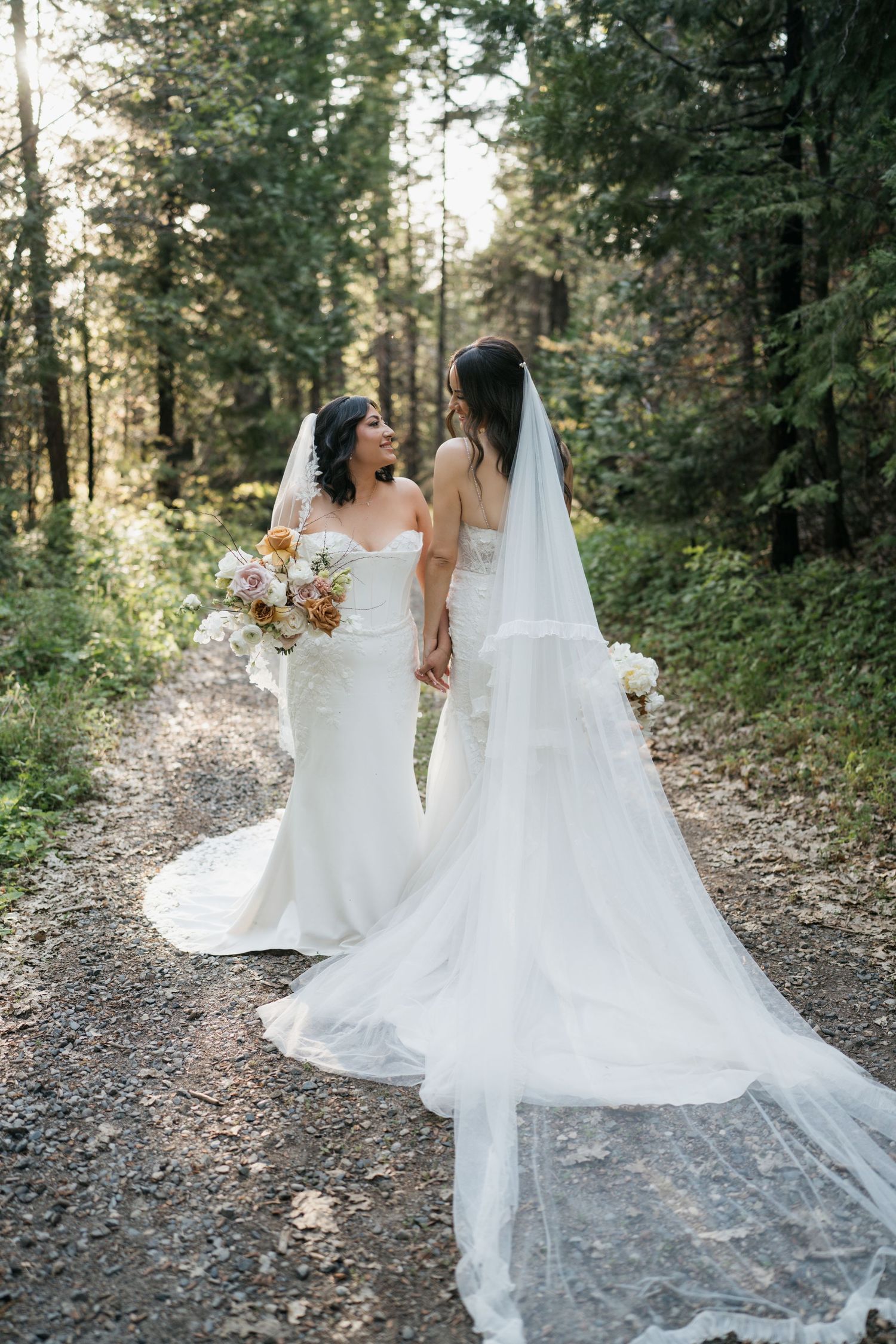 A tender wedding moment captured with the couple sharing an intimate moment among white flowers.