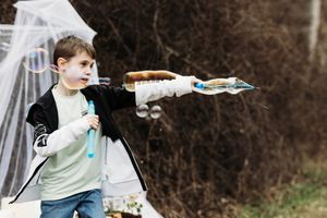 A boy playing with a toy rocket