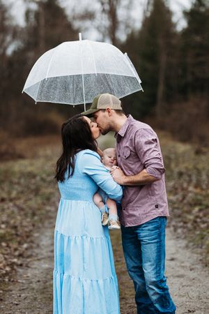 Family posing with an umbrella