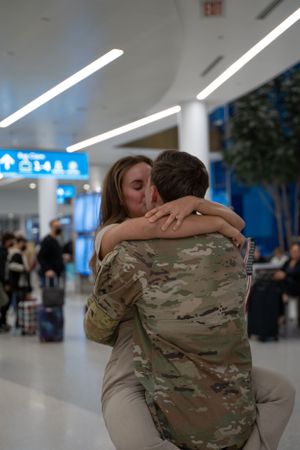 Military homecoming in the Charlotte Douglas International Airport captured by a couples photographer