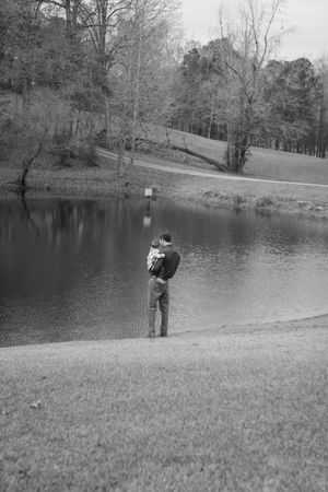 Black and white photos show people fishing at a tranquil pond surrounded by trees and grassy slopes.