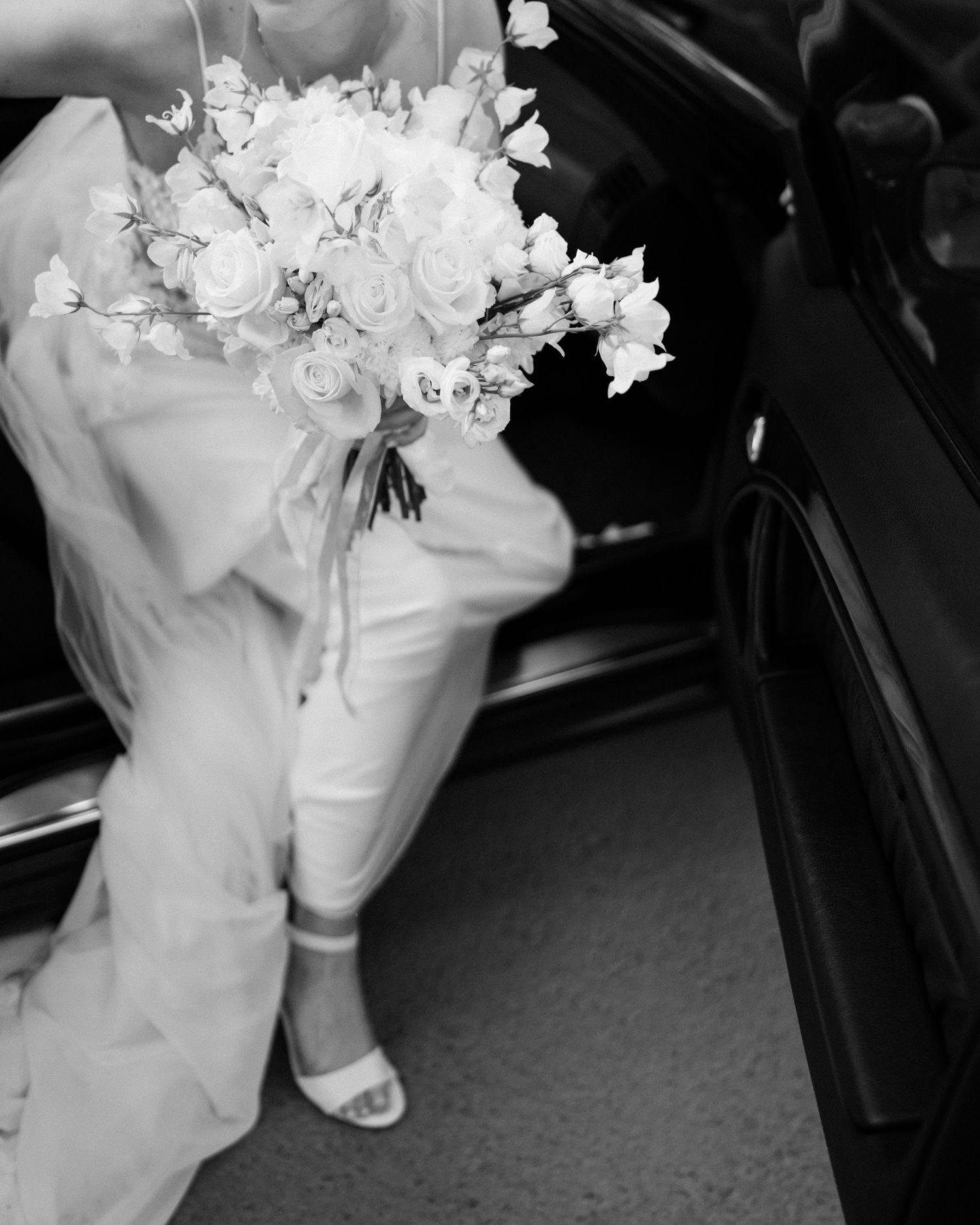 Black and white detail shot of bridal bouquet with white flowers.