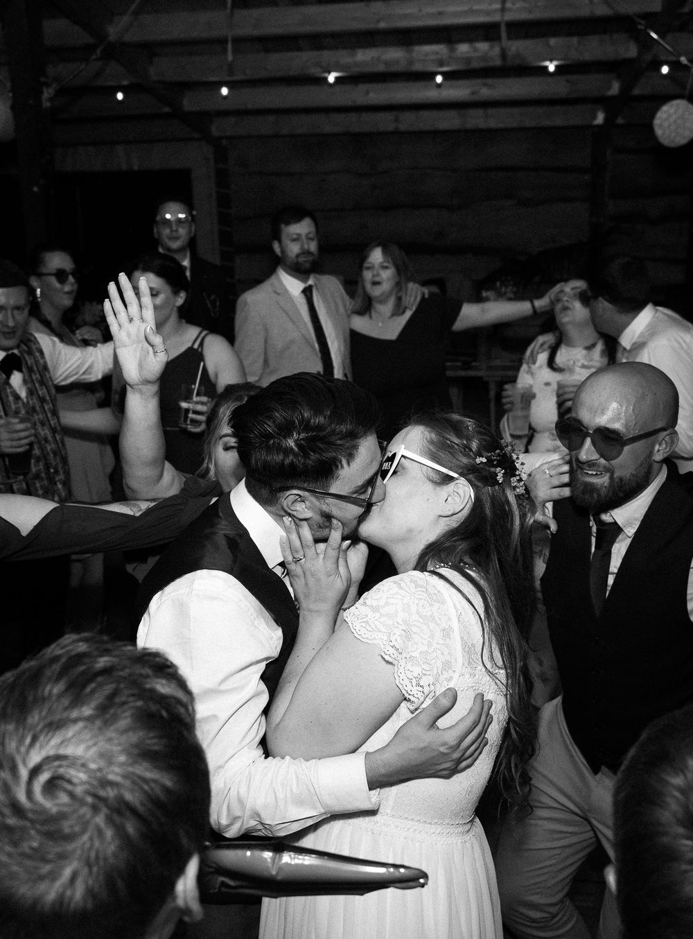 Black and white photo series showing couples dancing closely together at what appears to be a wedding reception.