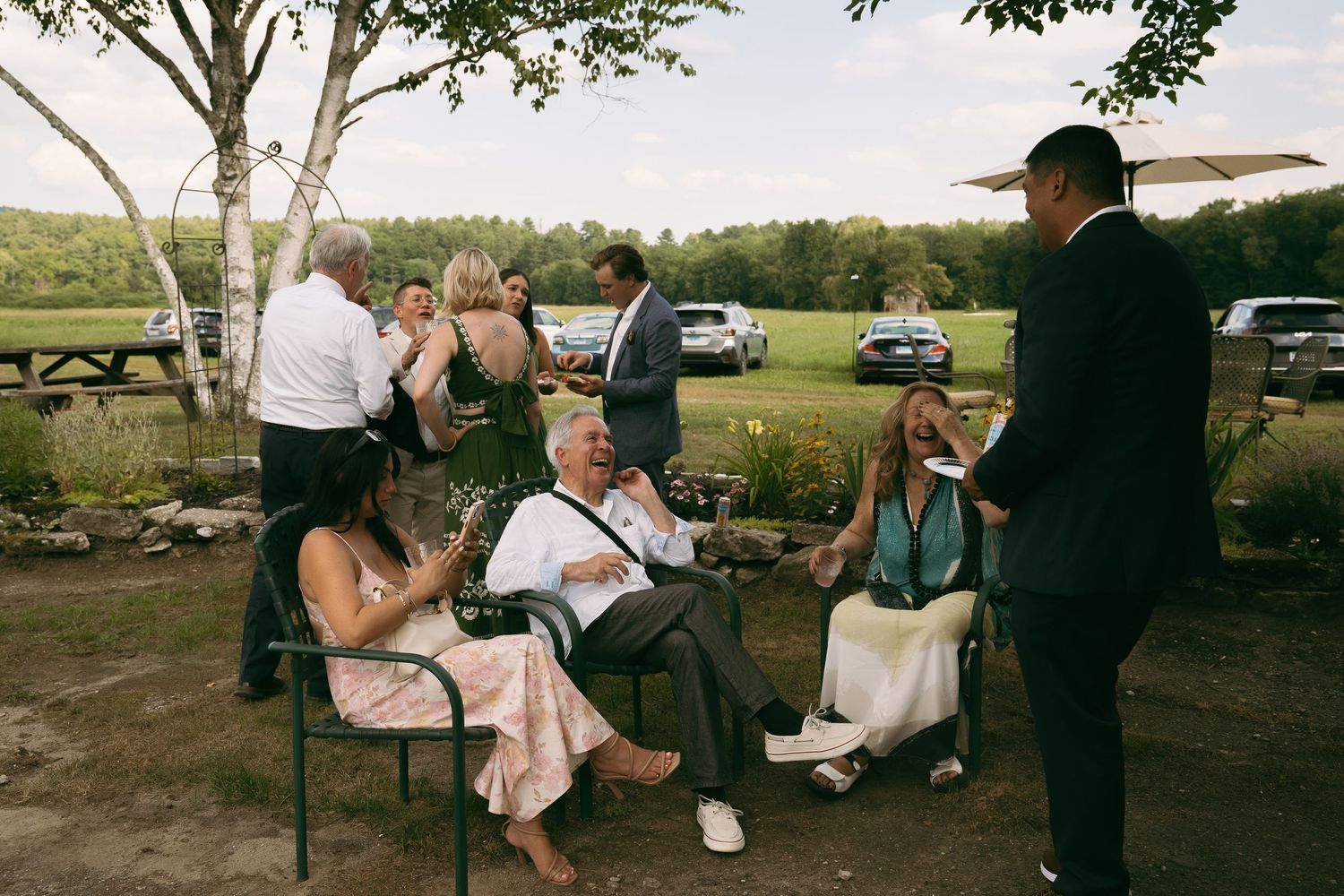 A romantic wedding moment with a bouquet of pink flowers being held during an outdoor ceremony.