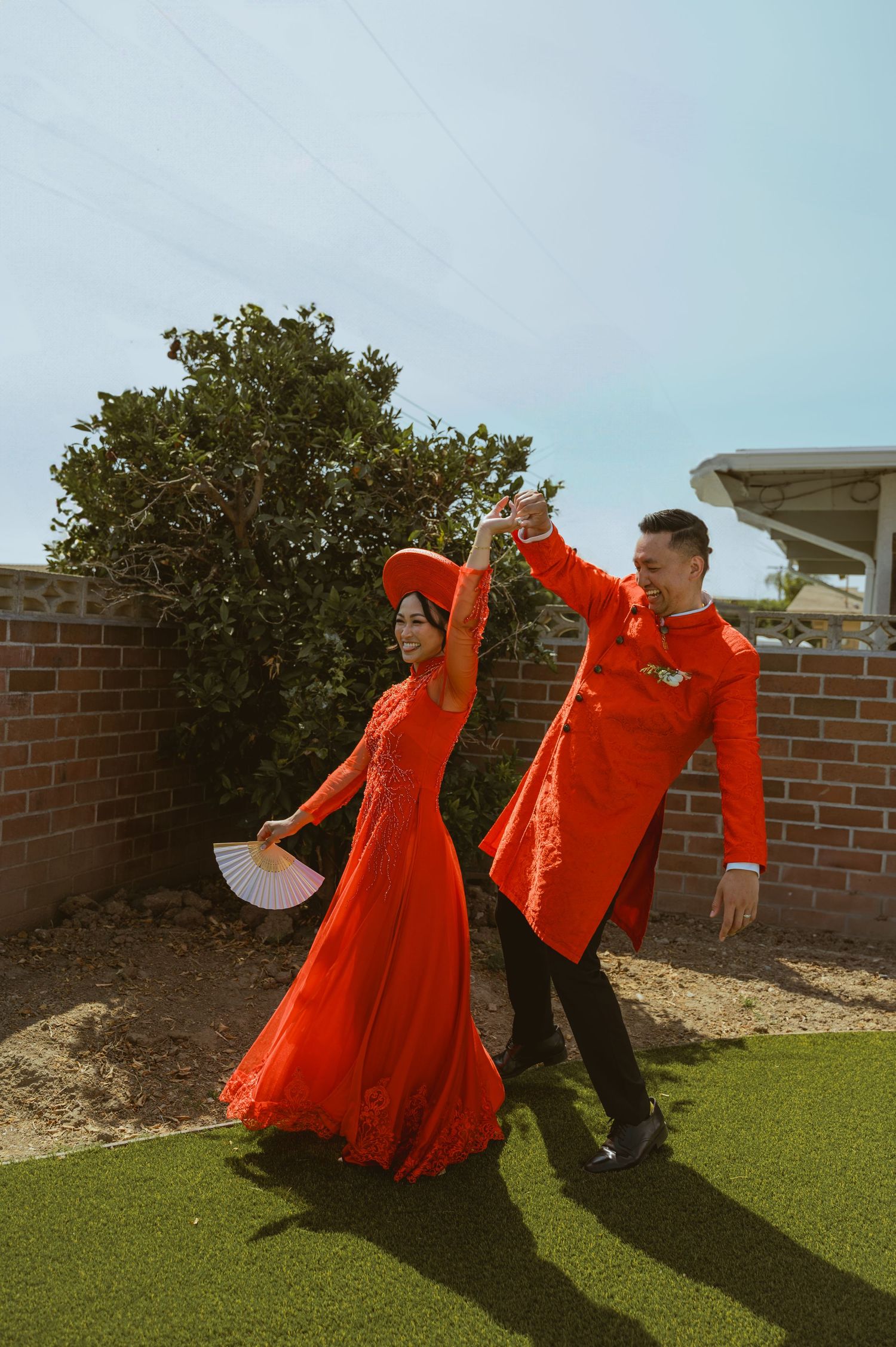 Dynamic dance photos showing vibrant red dresses twirling against a blue sky backdrop.