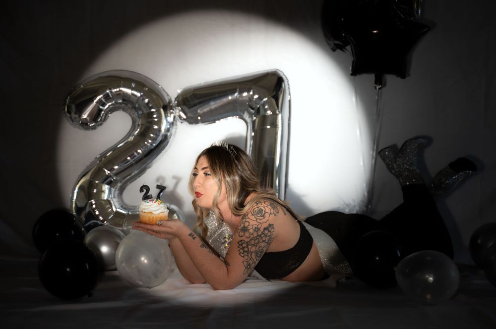 Artistic black and white portraits with silver balloons and dramatic spotlight effects.