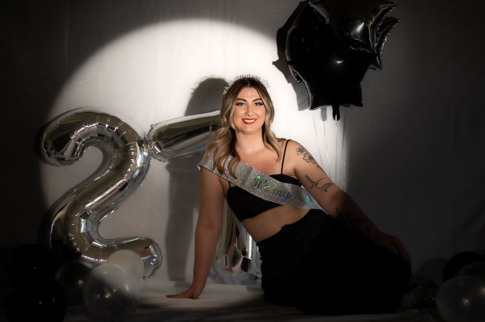 Dramatic studio portraits with silver balloon decorations and spotlighting effects.
