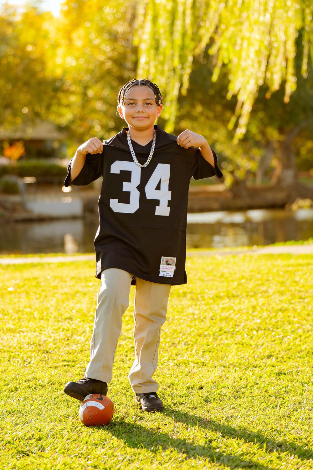 A series of playful shots in a sunny park with autumn leaves and a football.