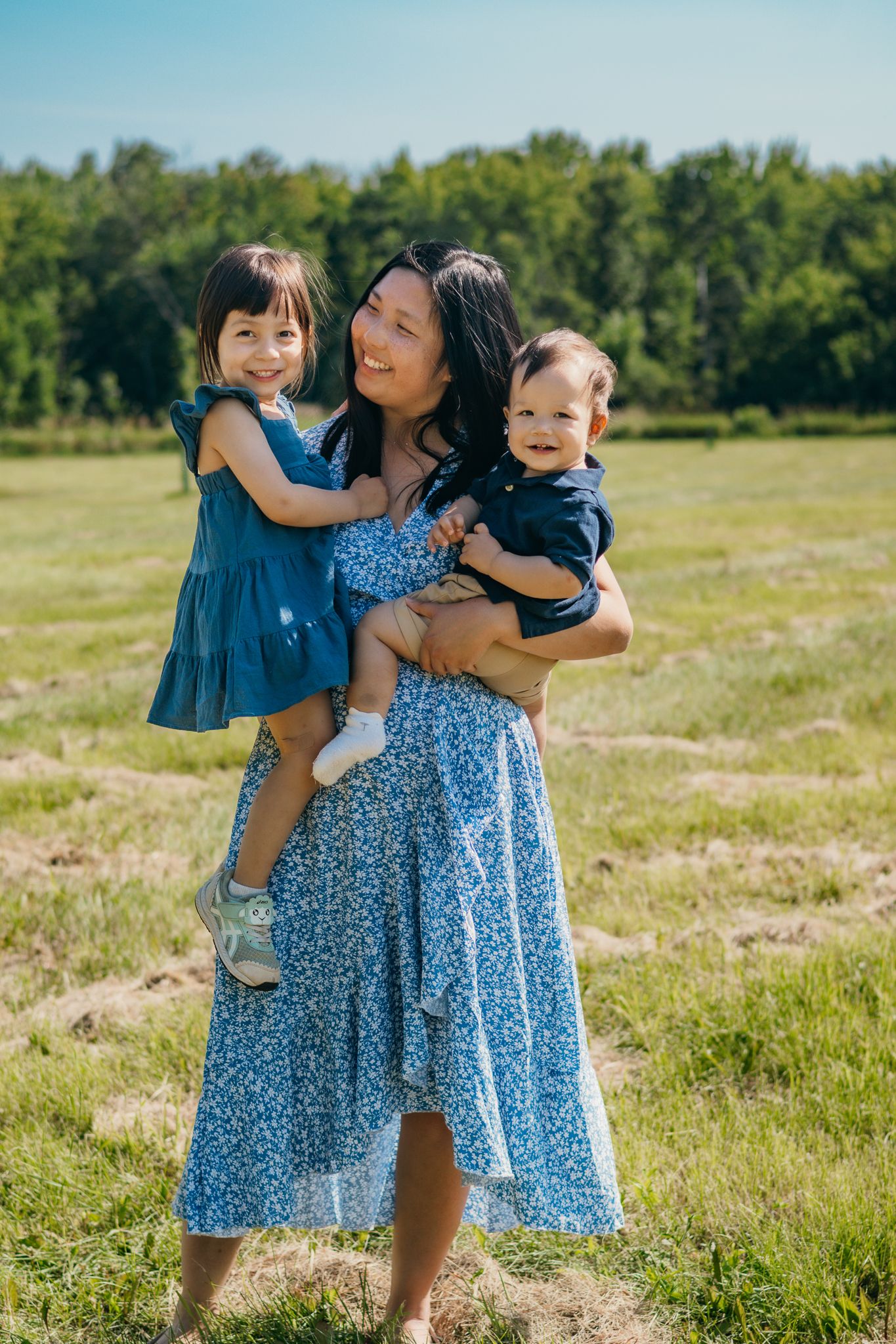 A mom and her two happy children in her arms