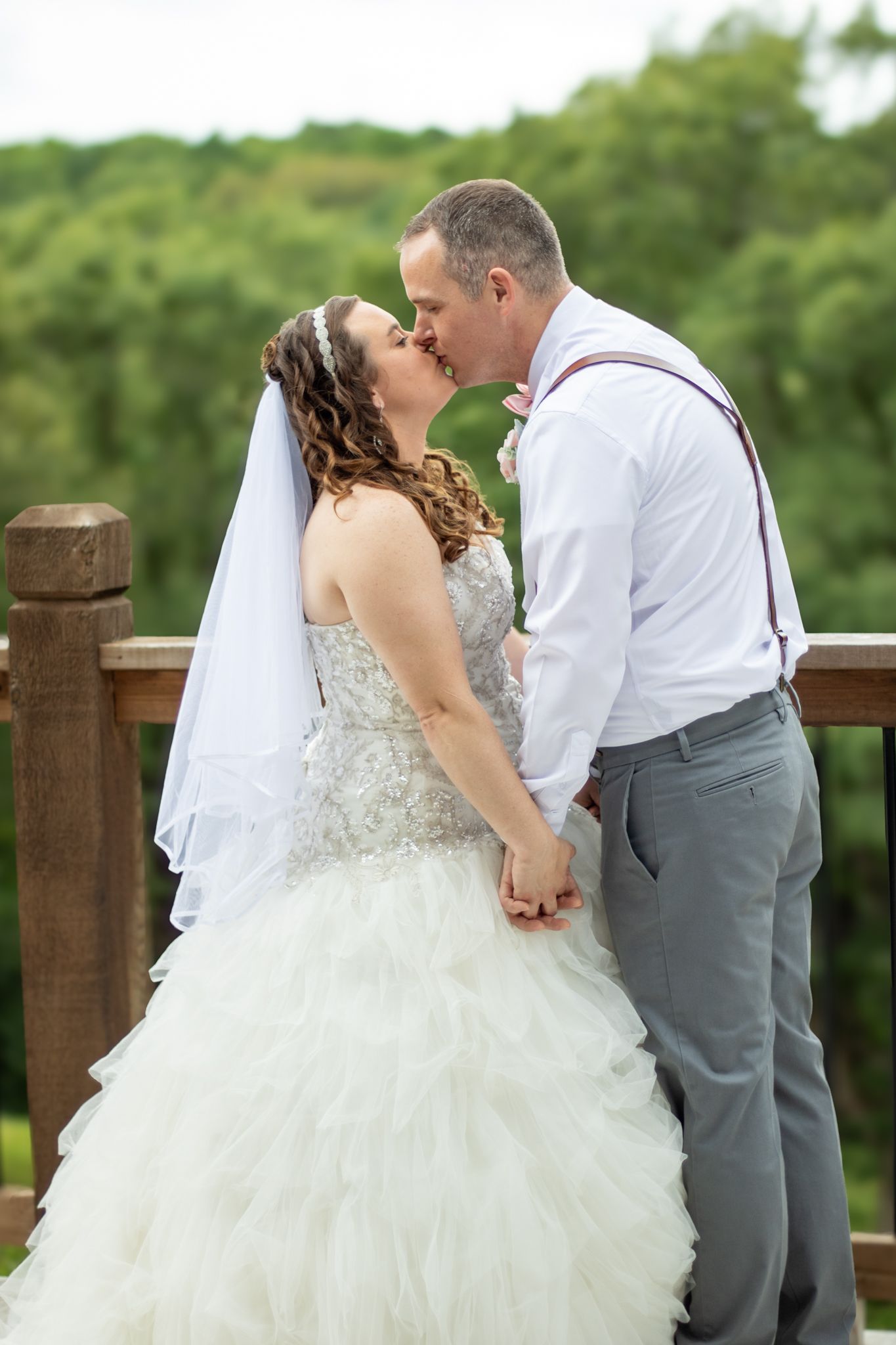 Bride and groom kissing outside at their wedding.